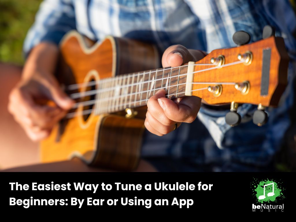 Close-up of hands strumming and fretting a ukulele, illustrating beginner-friendly tuning methods and techniques, including using an app or tuning by ear for accurate pitch.